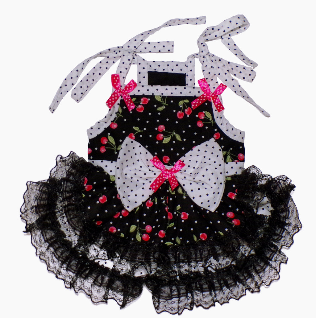 Black dress with red floral patterns and white polka dot ribbons on a white background