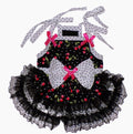Black dress with red floral patterns and white polka dot ribbons on a white background