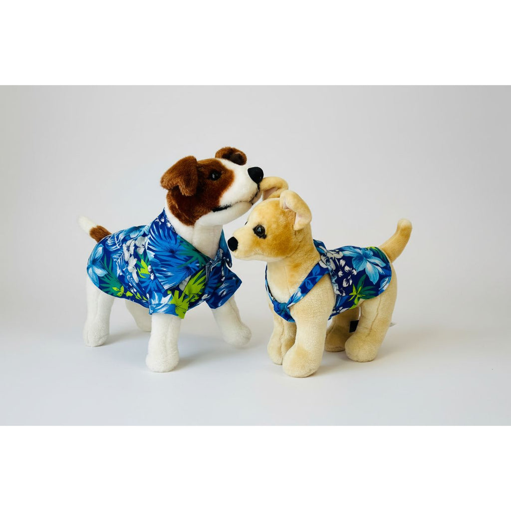 Two stuffed dogs wearing blue floral outfits on a white background