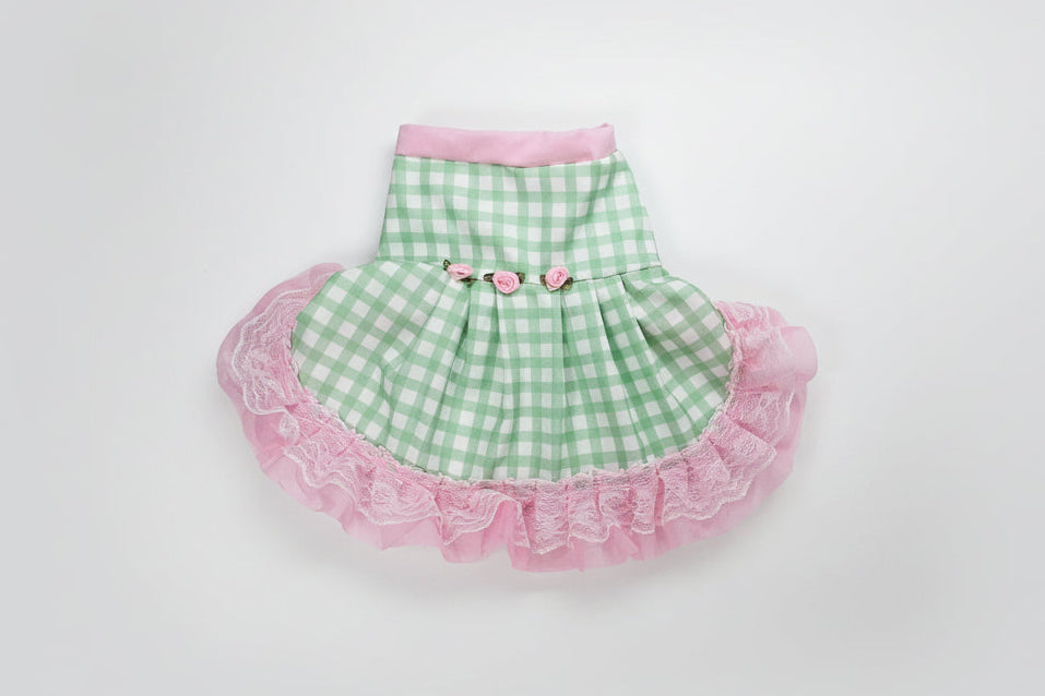 Green checkered pet dress with pink ruffle on a white background