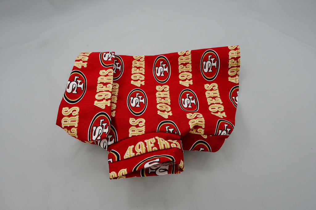 Red fabric dog shirt with San Francisco 49ers logo on a white background