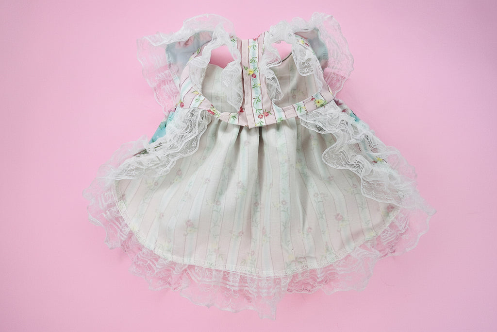 dog dress with floral details on a pink surface