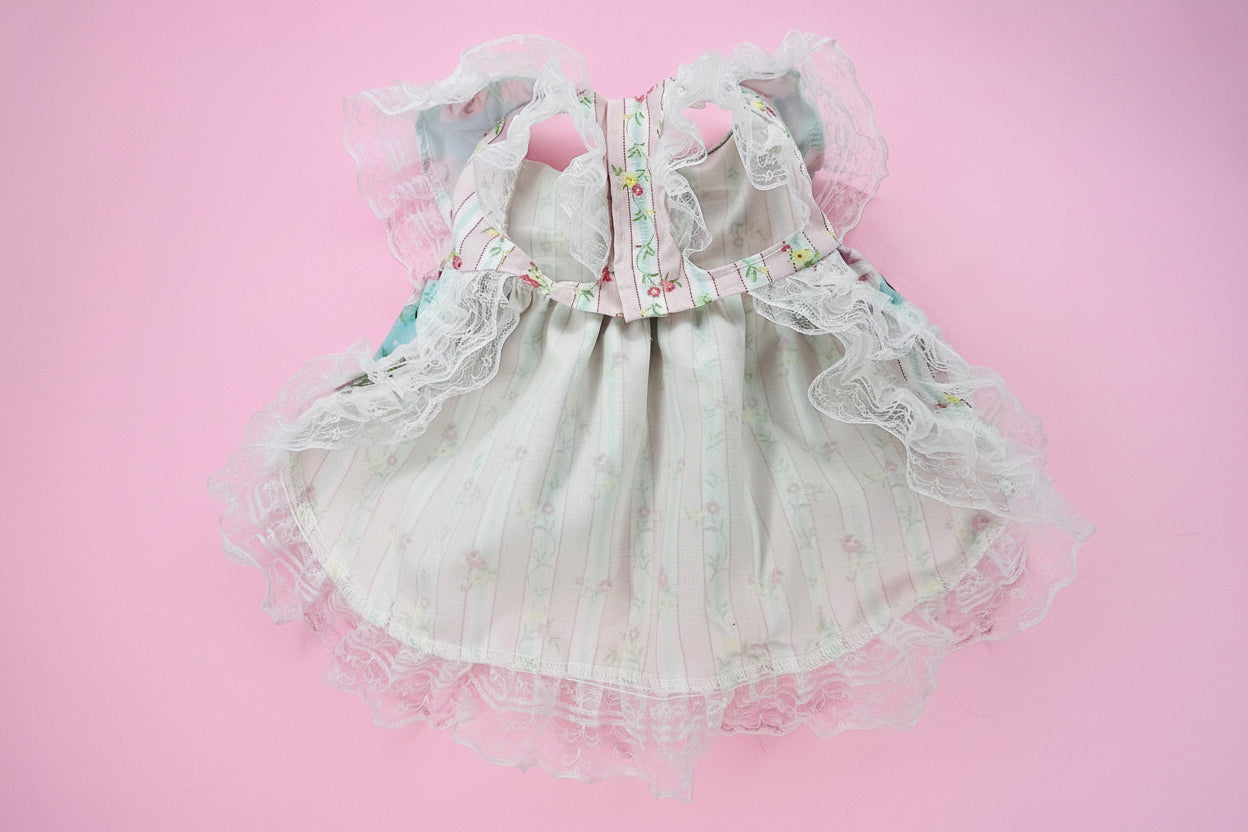 dog dress with floral details on a pink surface