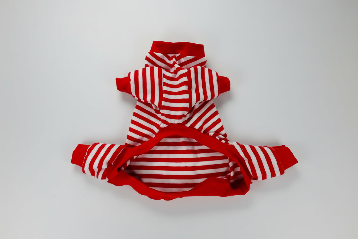 Red and white striped dog pajamas on a white surface