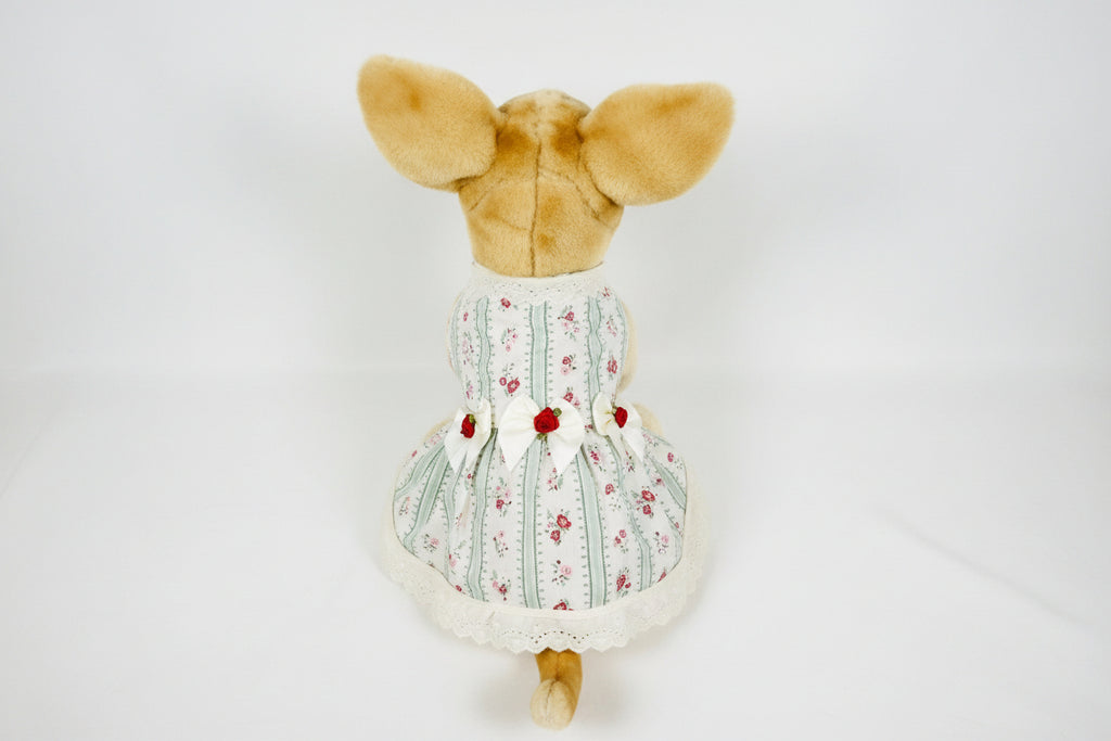 Stuffed animal wearing a floral dress on a white background