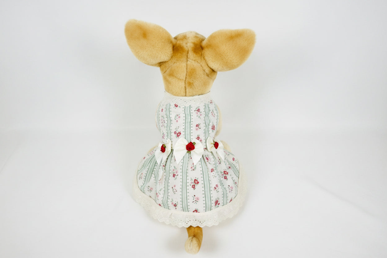 Stuffed animal wearing a floral dress on a white background