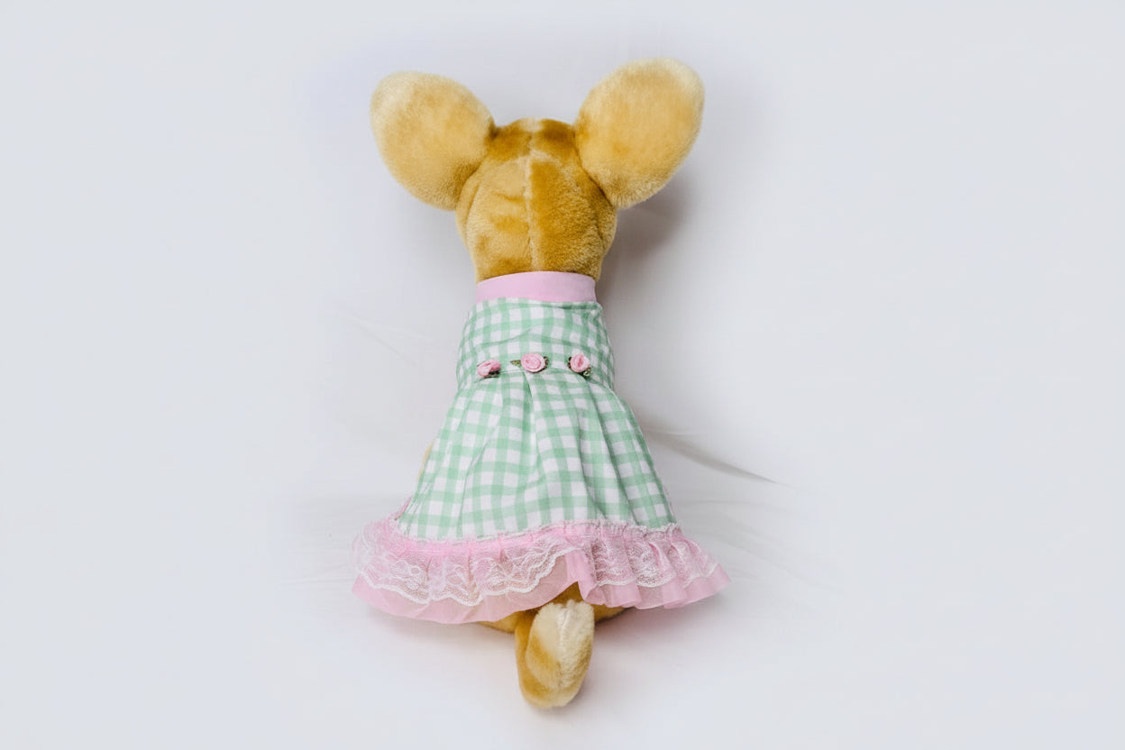Plush toy with a green checkered dress on a white background