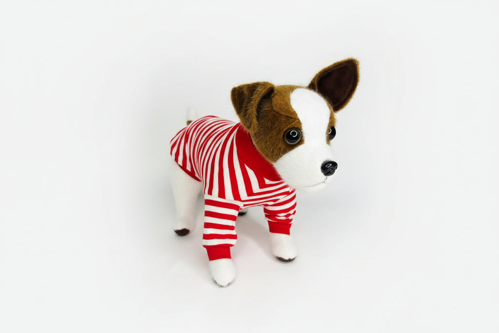 Stuffed dog toy wearing a red and white striped outfit on a white background