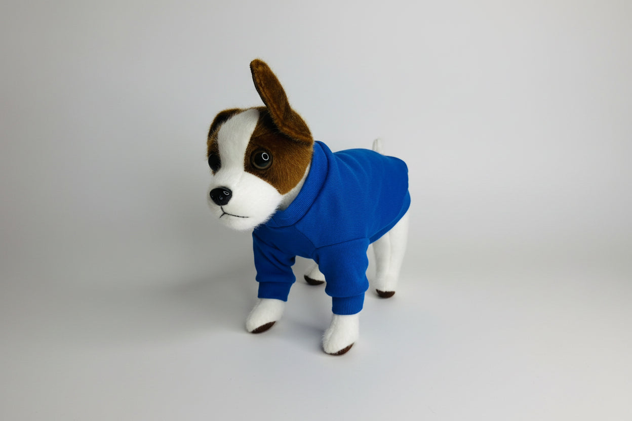 Stuffed dog toy wearing a blue hoodie on a white background