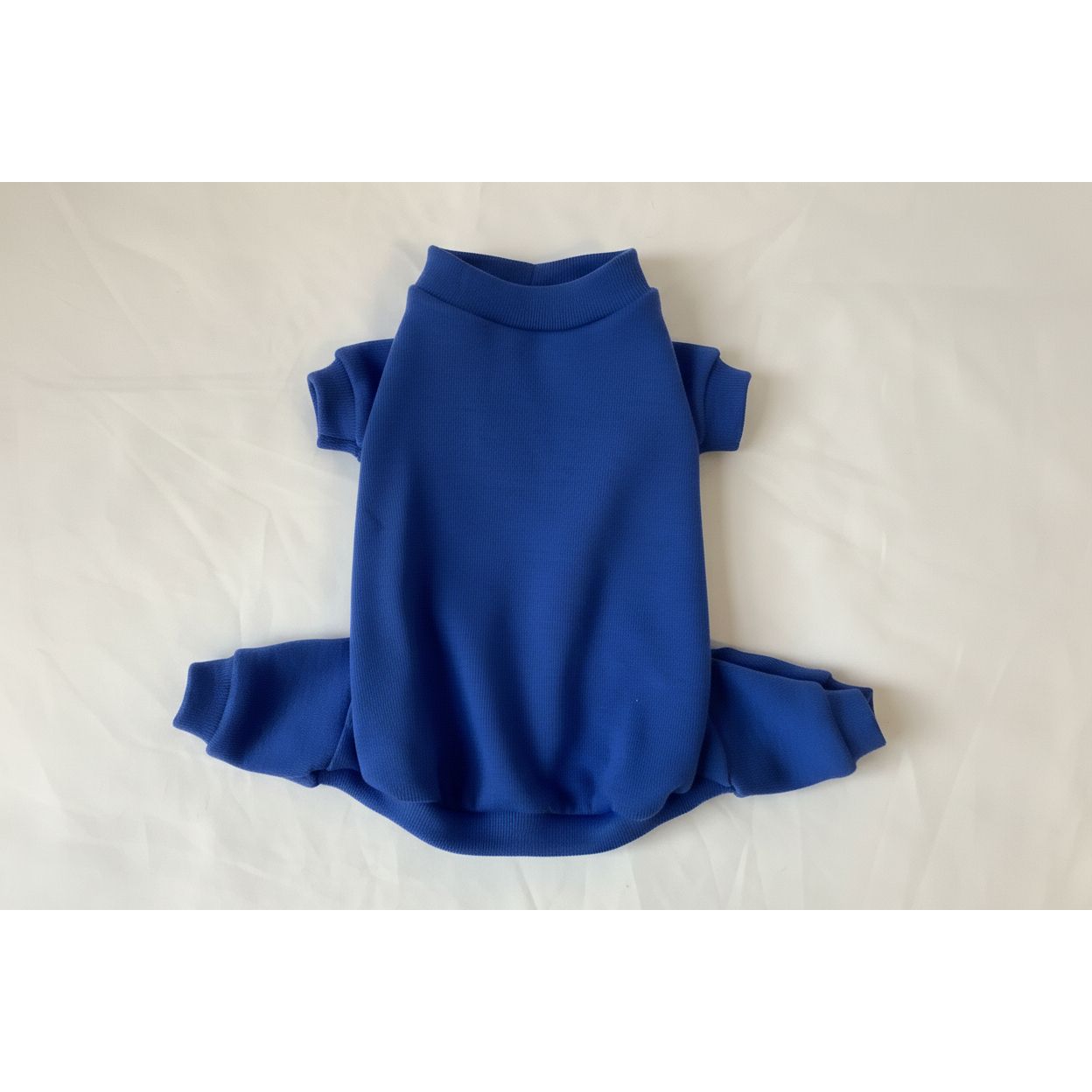Blue dog pajamas on a white bedspread