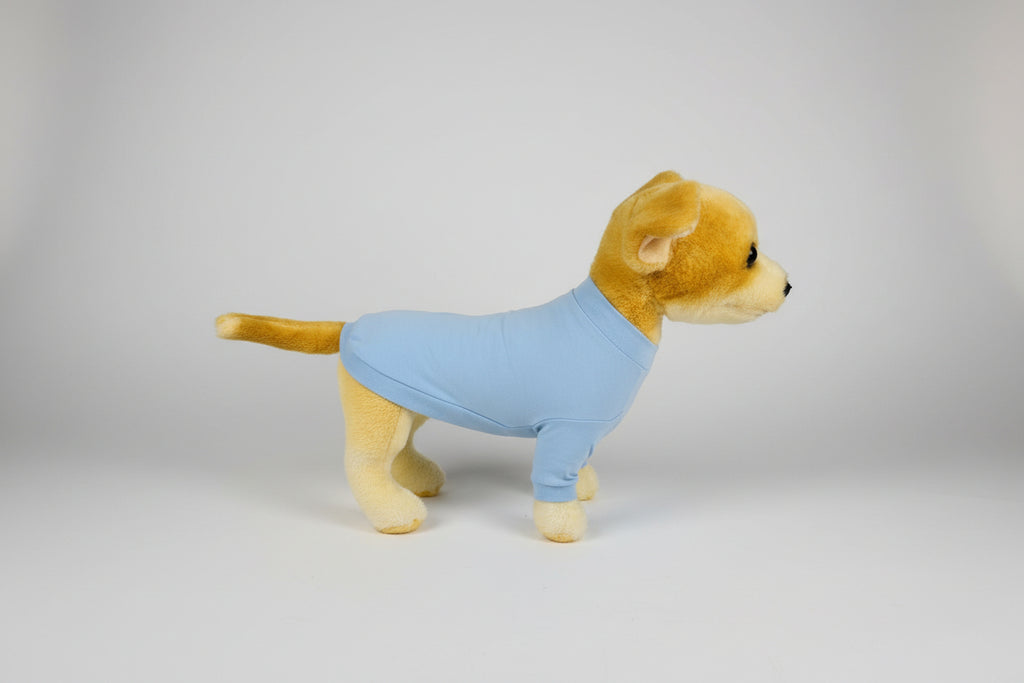 Stuffed lion toy wearing a blue shirt on a white background