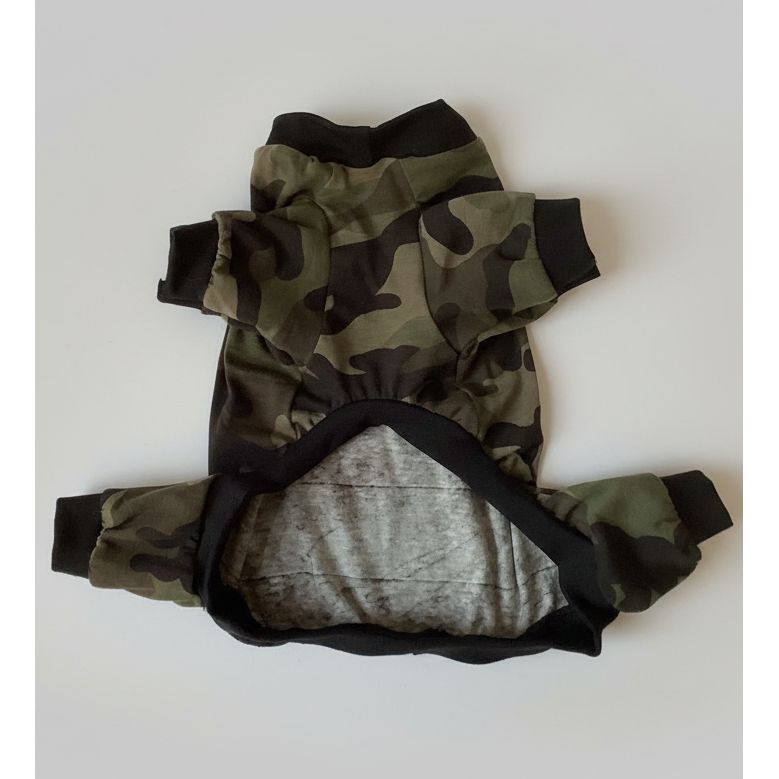 Camouflage dog pajamas on a white bedspread