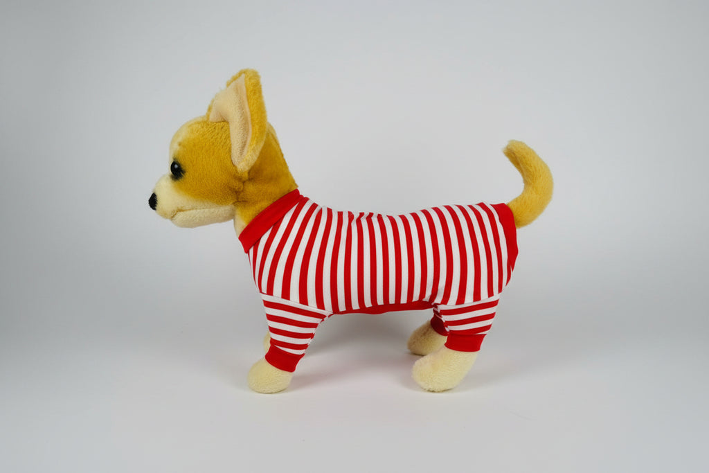 Stuffed dog toy wearing a red and white striped outfit on a white background