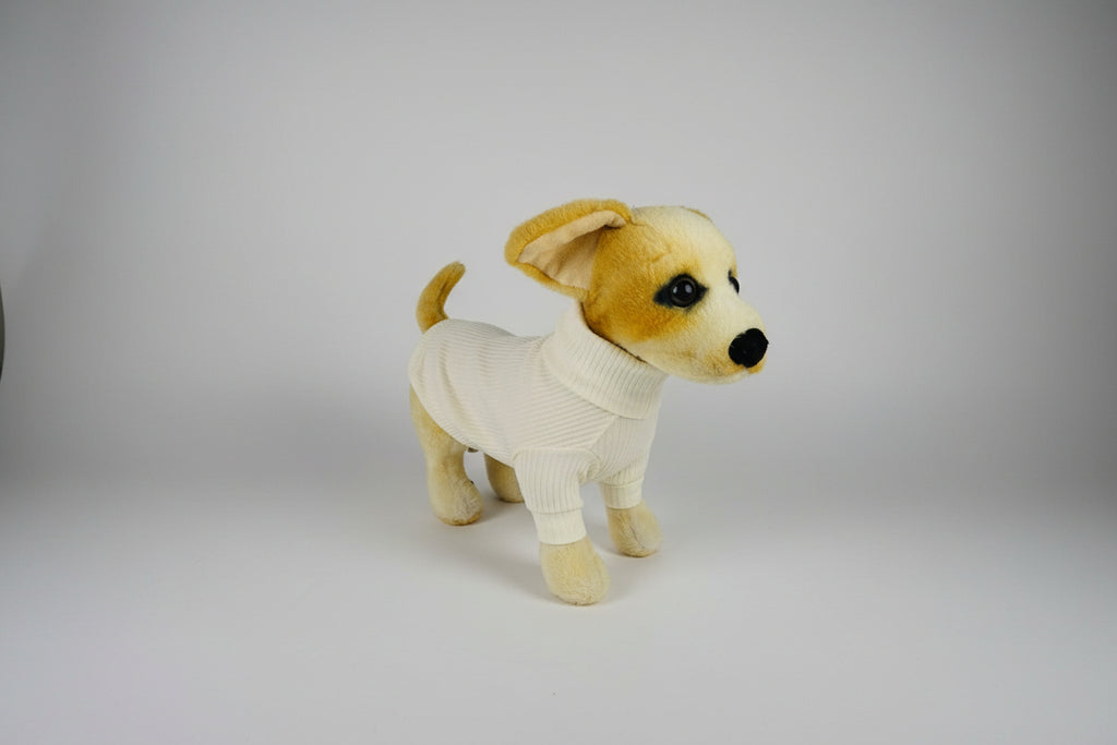 Plush dog toy wearing a sweater on a white background