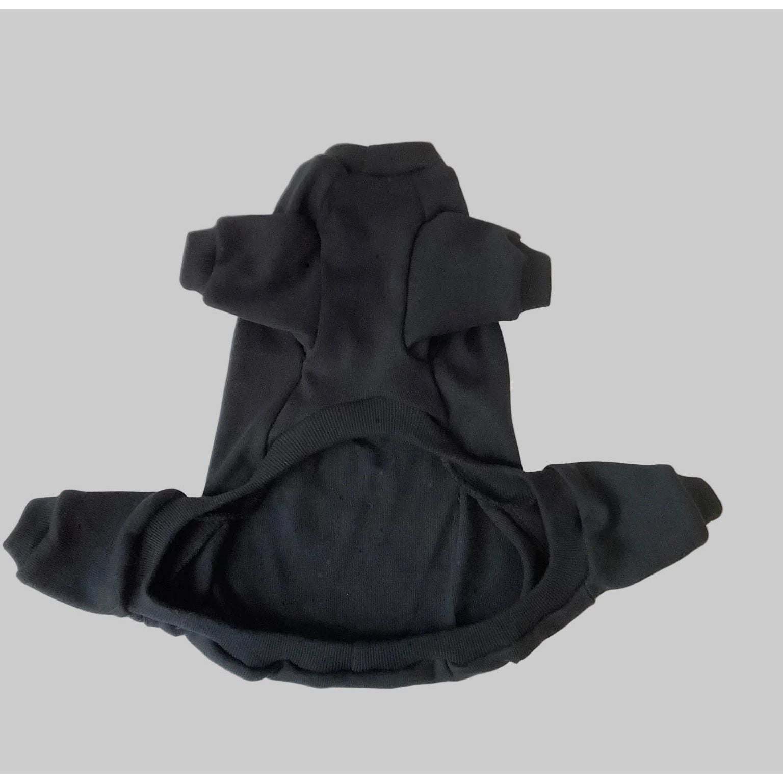 Black dog pajamas on a white sheet