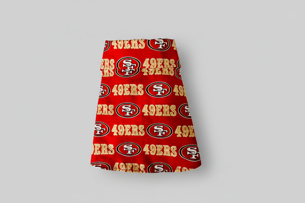 Red fabric dog shirt with San Francisco 49ers logo and text on a white background