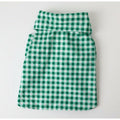 Green and white checkered fabric dog shirt on a white background