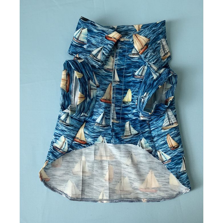 Folded shirt with sailboat pattern on a light background