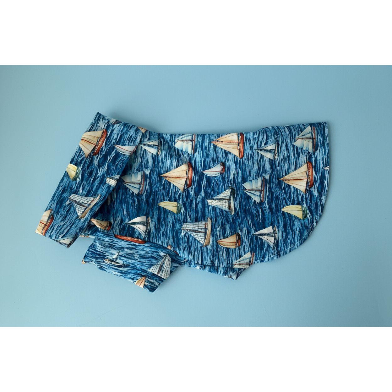 dog shirt with sailboat pattern on a white background