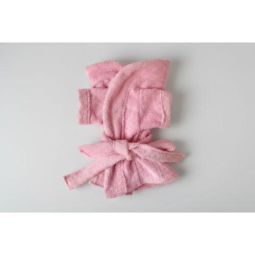 Pink  dog robe on a white surface
