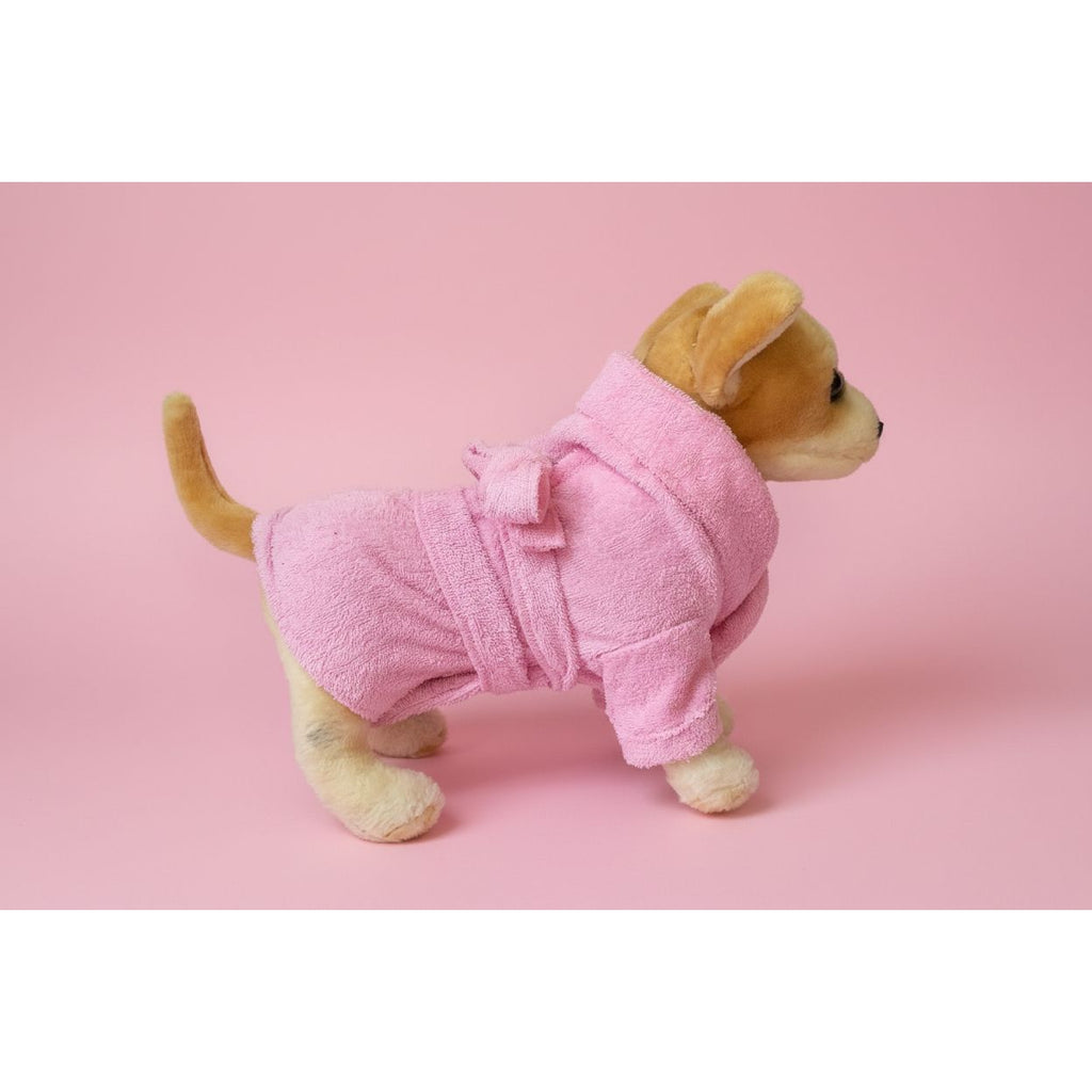 Stuffed dog toy wearing a pink robe on a white background