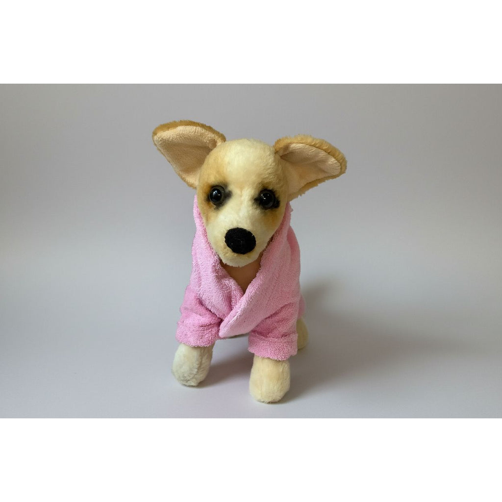 Stuffed dog toy wearing a pink robe on a white background