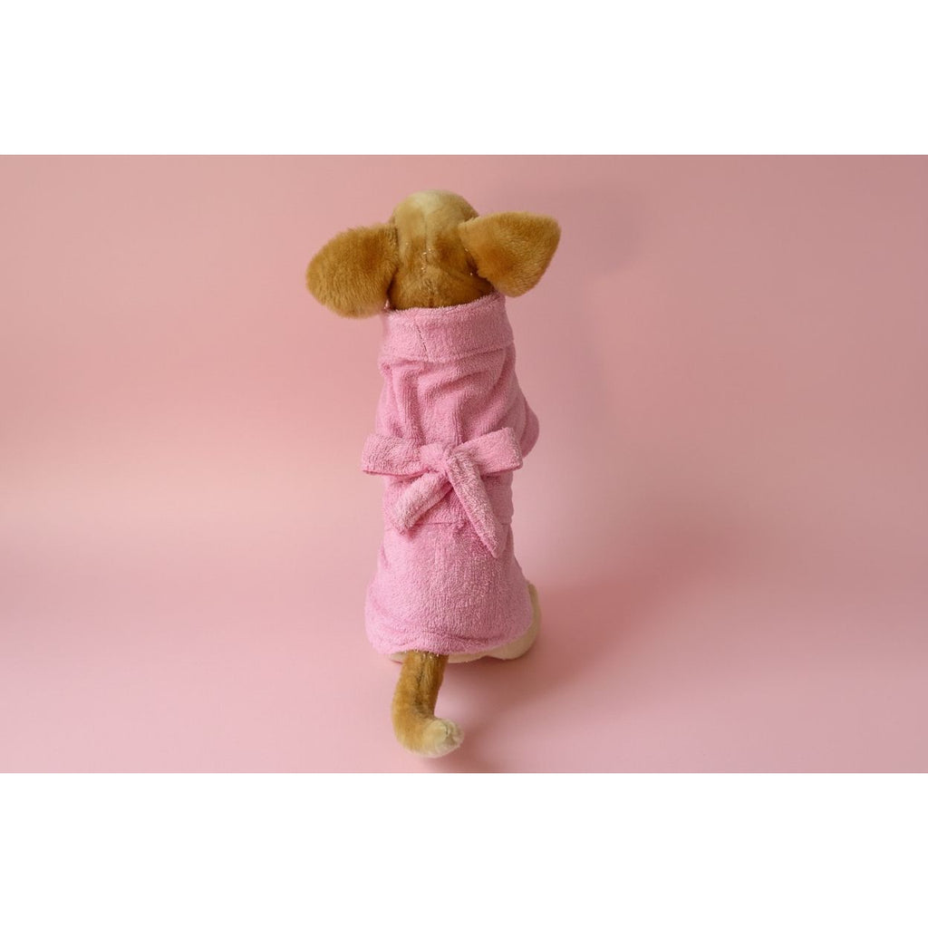 Stuffed animal in a pink robe on a white background