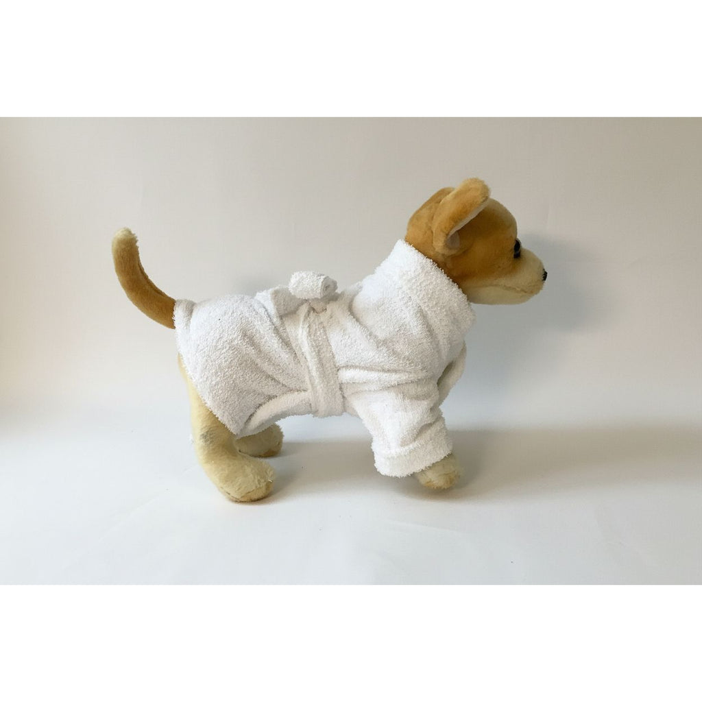 Stuffed dog toy wearing a white robe on a white background