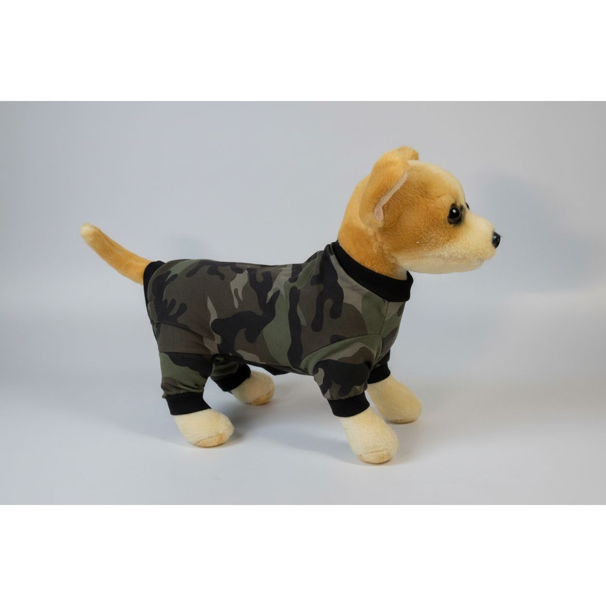 Plush dog toy wearing a camouflage outfit on a white background