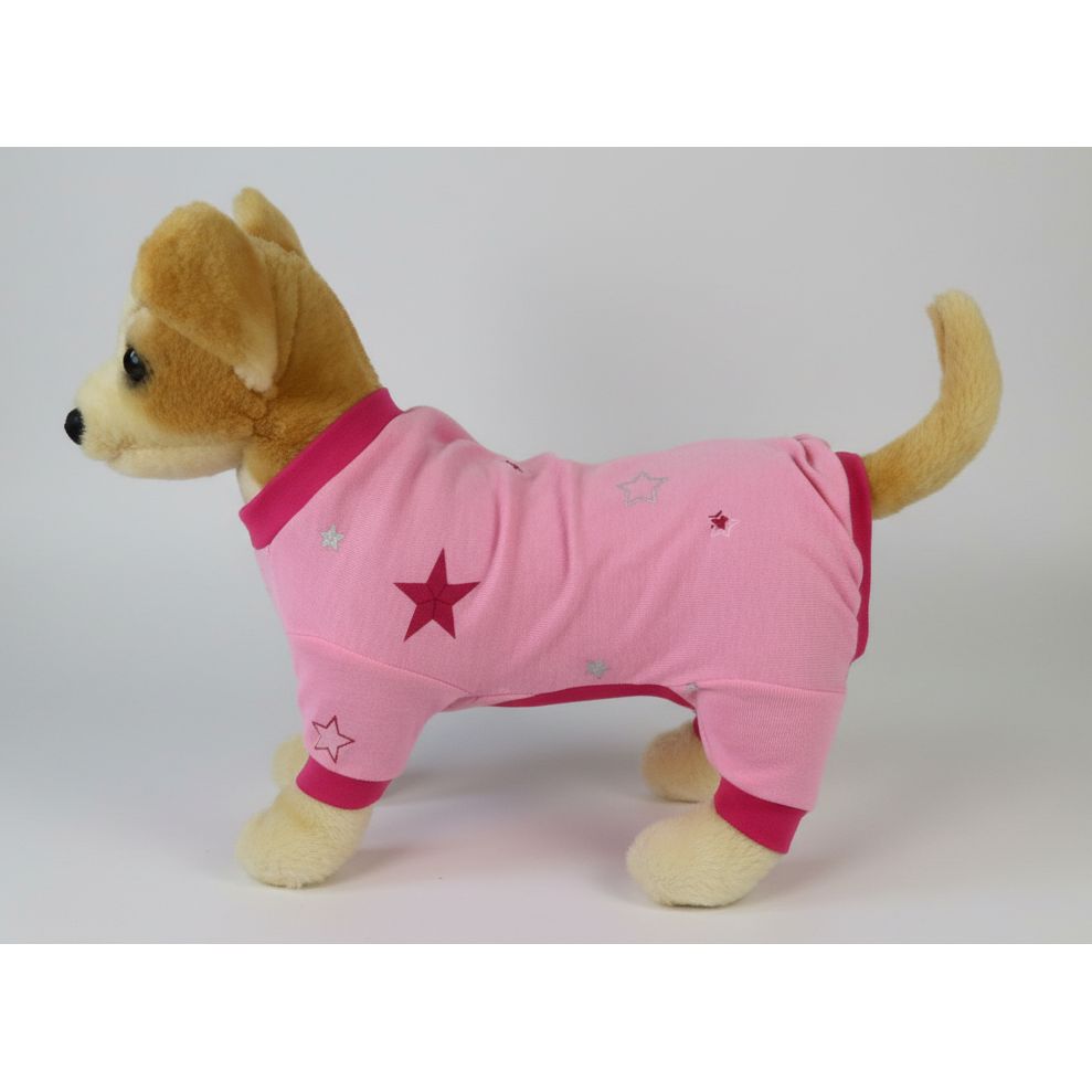 Stuffed dog wearing a pink outfit with stars on a white background