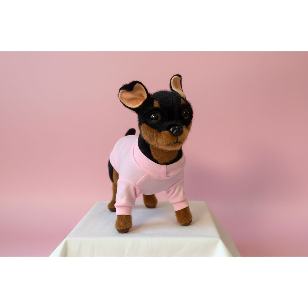 Plush dog toy wearing a pink outfit on a white background