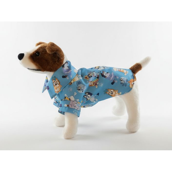 dog wearing a bluey shirt with cartoon character pattern on a white background