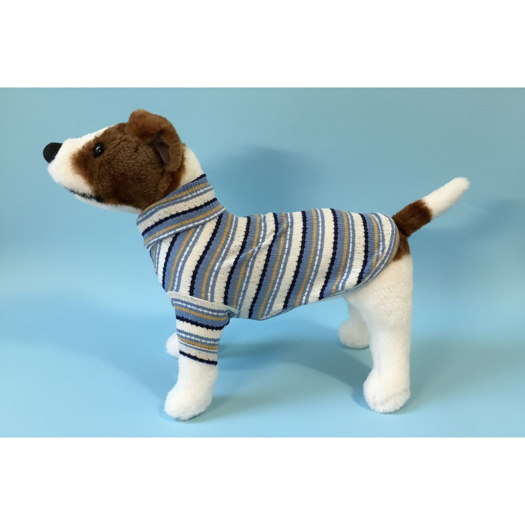 Dog wearing a striped sweater against a white background