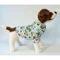 Dog wearing a keroppi dog shirt on a white background
