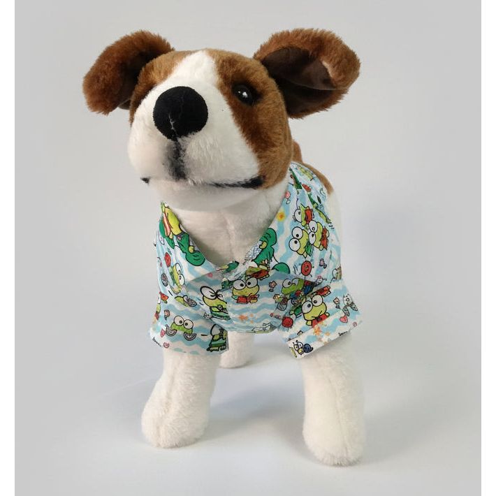 Stuffed dog wearing a keroppi dog shirt on a white background