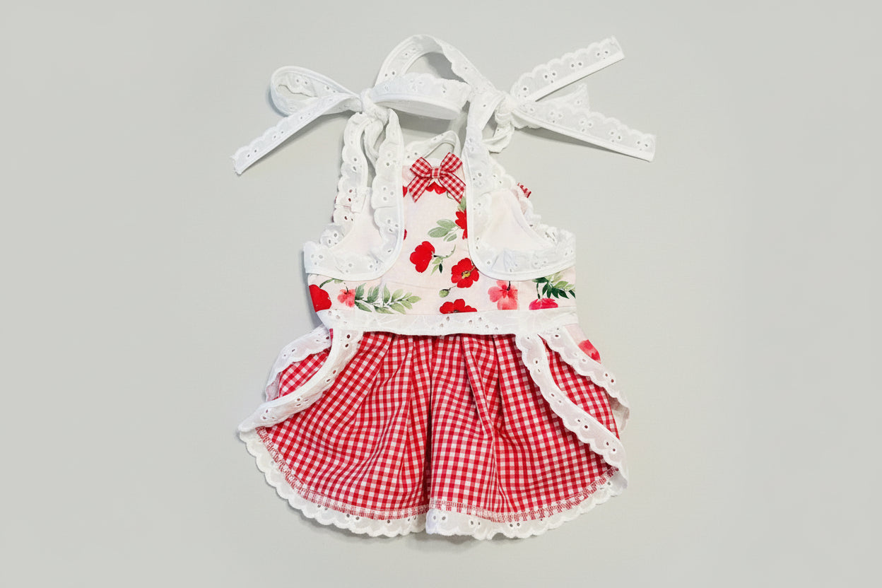 Children's outfit with floral top and red checkered shorts on a marble surface