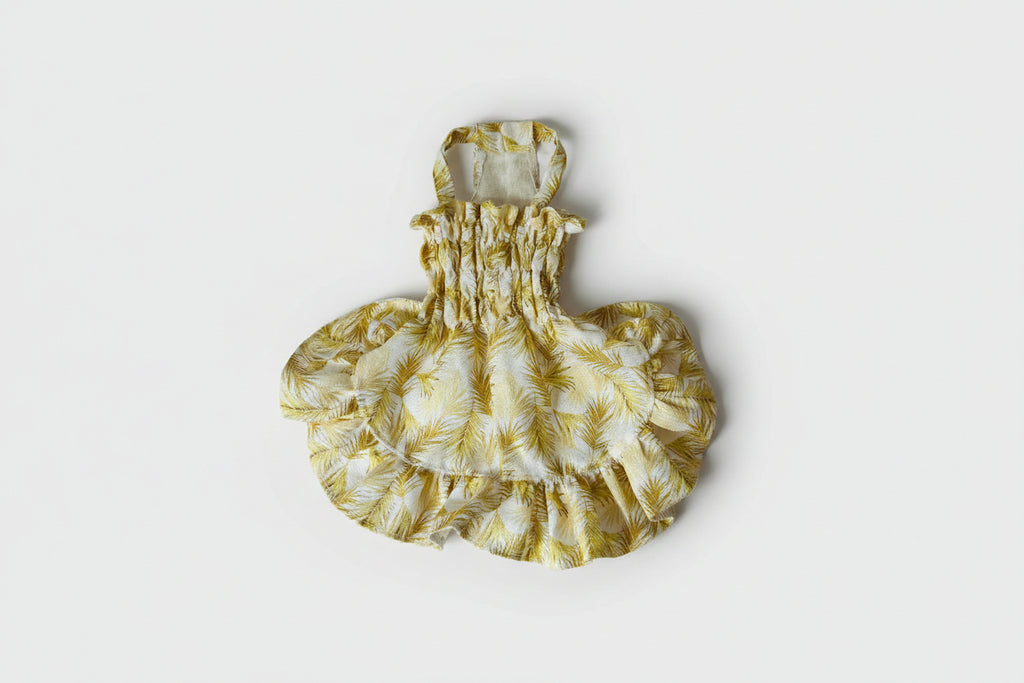 Yellow floral dress on a white surface
