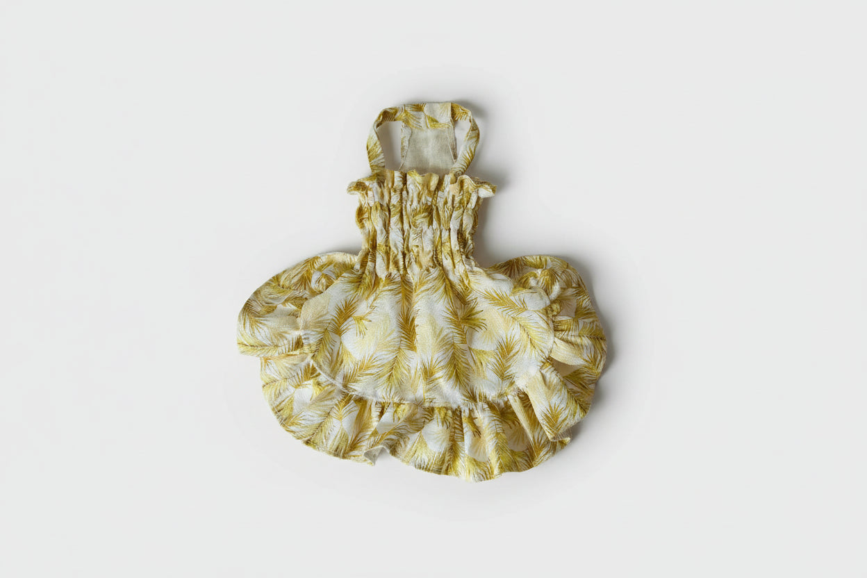 Yellow floral dress on a white surface