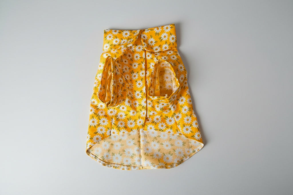 yellow shirt on white surface