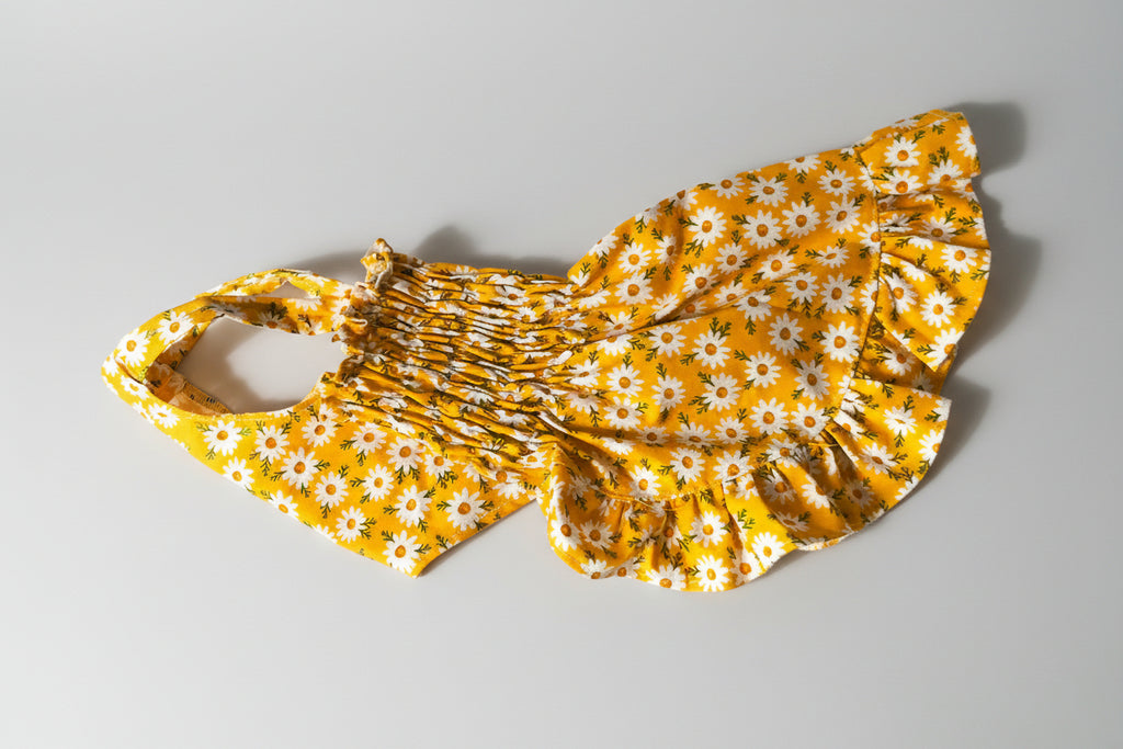 Yellow floral dress on a white surface