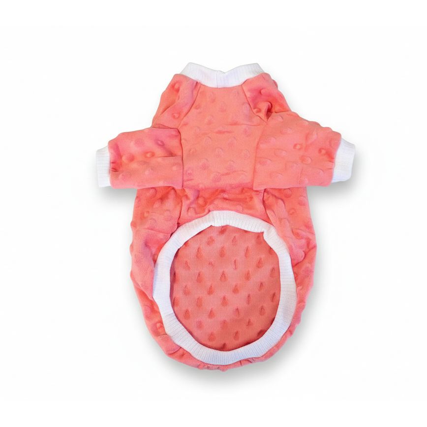 Pink pet outfit with white trim on a textured beige surface