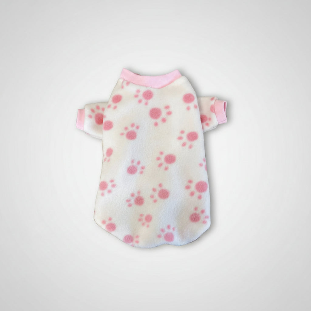 White pet sweater with pink floral pattern on a textured surface
