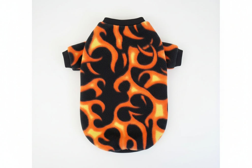 Dog sweater with orange and black flame pattern on a gray background