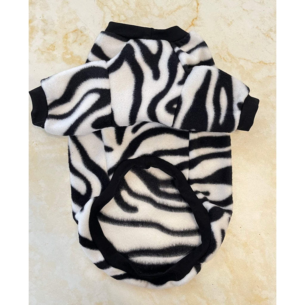 Zebra patterned pet outfit on a beige surface