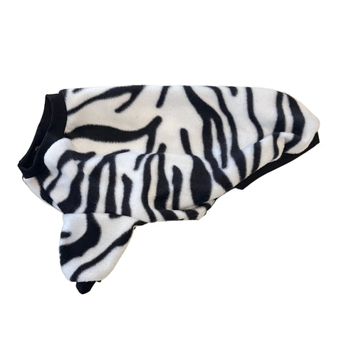 Zebra-patterned dog coat on a beige marble surface