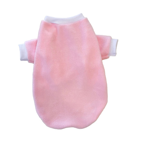 Pink dog sweater on a marble surface