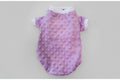 Purple textured baby romper on a pink background