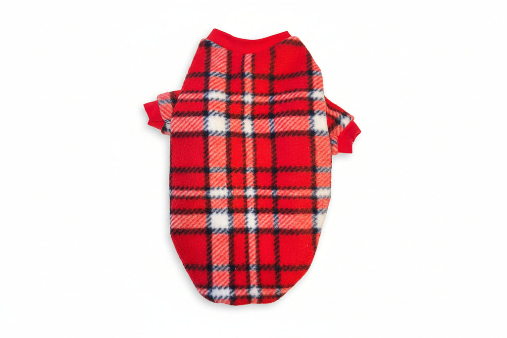 Red plaid dog sweater on a textured beige background