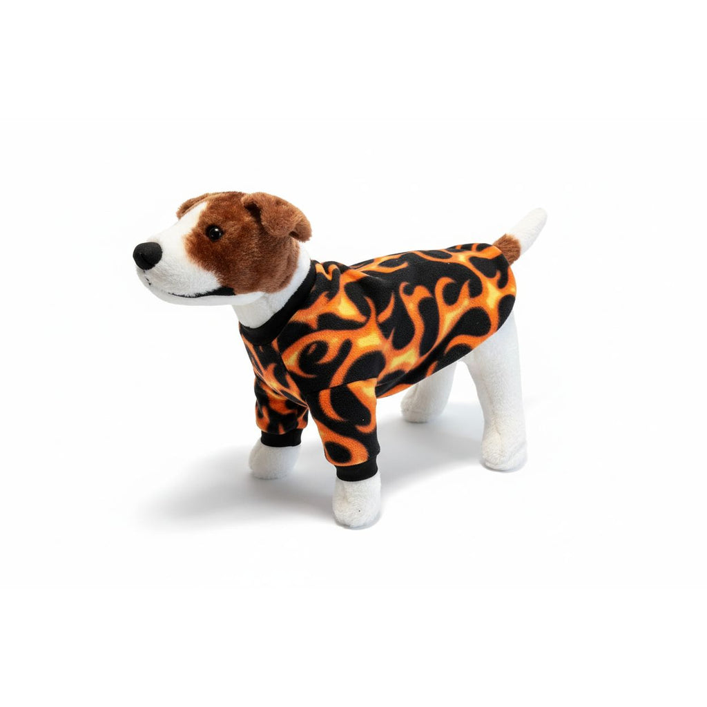 Dog wearing a flame-patterned outfit on a beige couch
