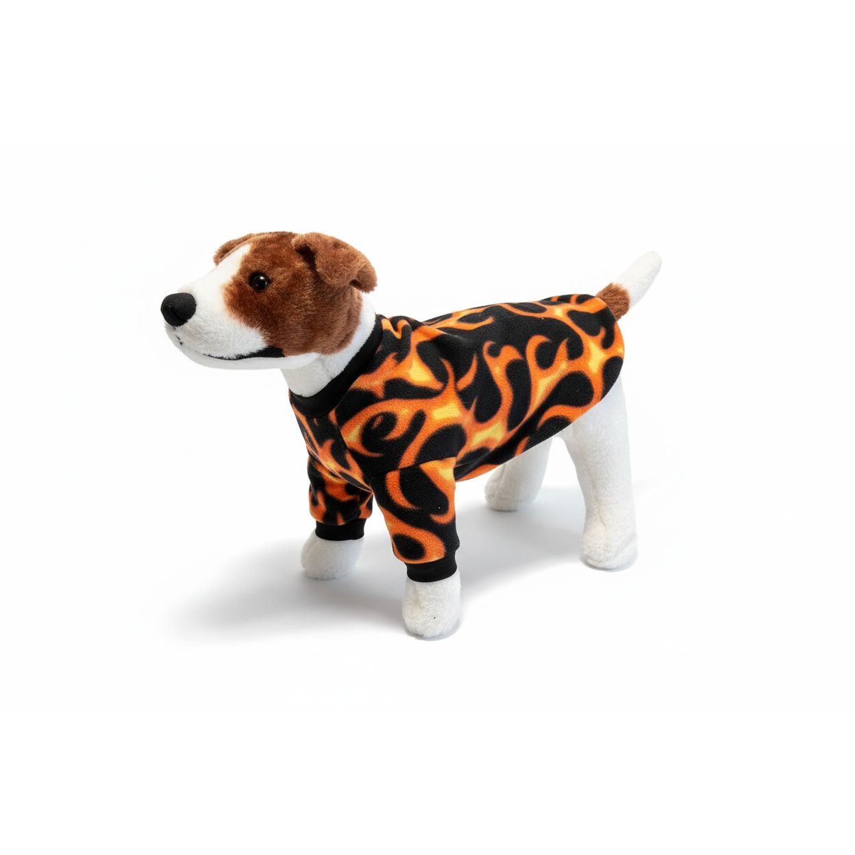 Dog wearing a flame-patterned outfit on a beige couch